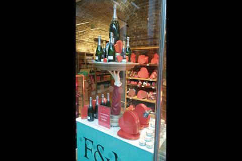 Each tray bears champagne bottles and heart-shaped chocolate boxes with a sign beneath stating: “Love Everlasting is a gift from Fortnum’s”.